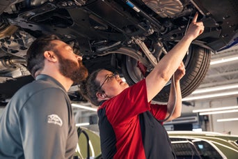 Service technician serving vehicle.