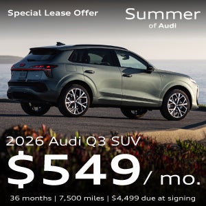 An Audi Q3 parked near water.