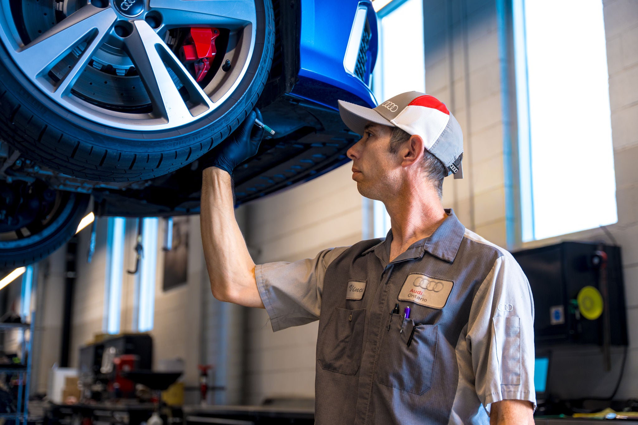 Audi A3 being serviced in the shop.