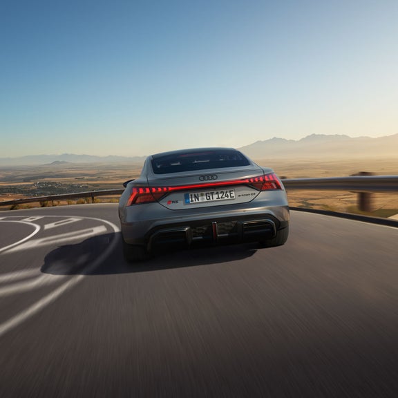 Three-quarter rear view of the Audi RS e-tron GT accelerating.