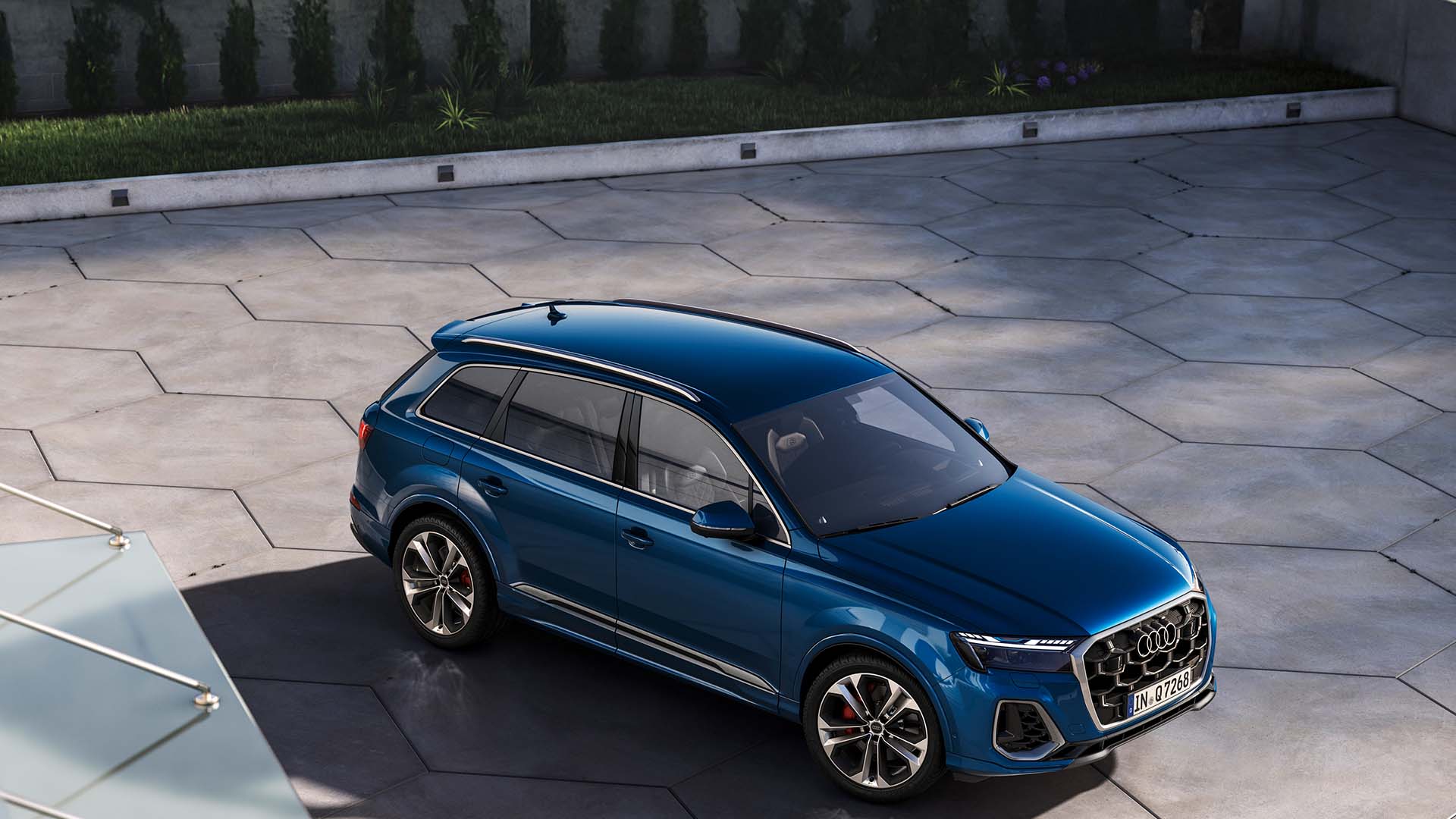 Left profile view of an Audi vehicle parked.