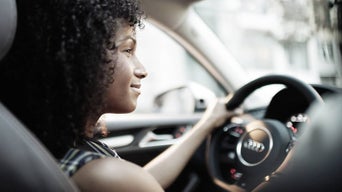 A woman driving an Audi
