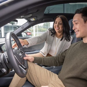 Couple test driving a Certified pre-owned Audi — schedule yours at Audi Sewickley near Pittsburgh