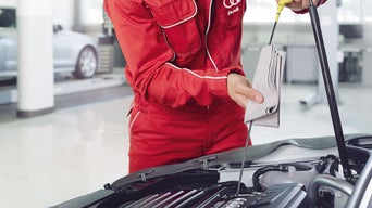 Service technicians changing oil.