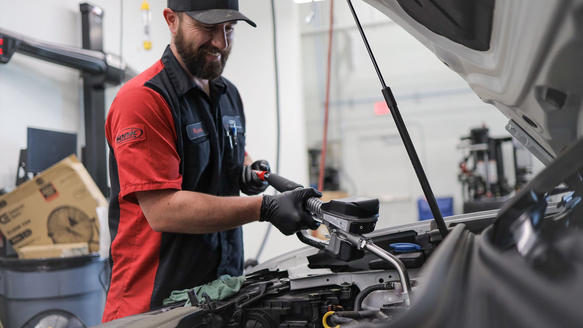 Audi service technician servicing a vehicle.