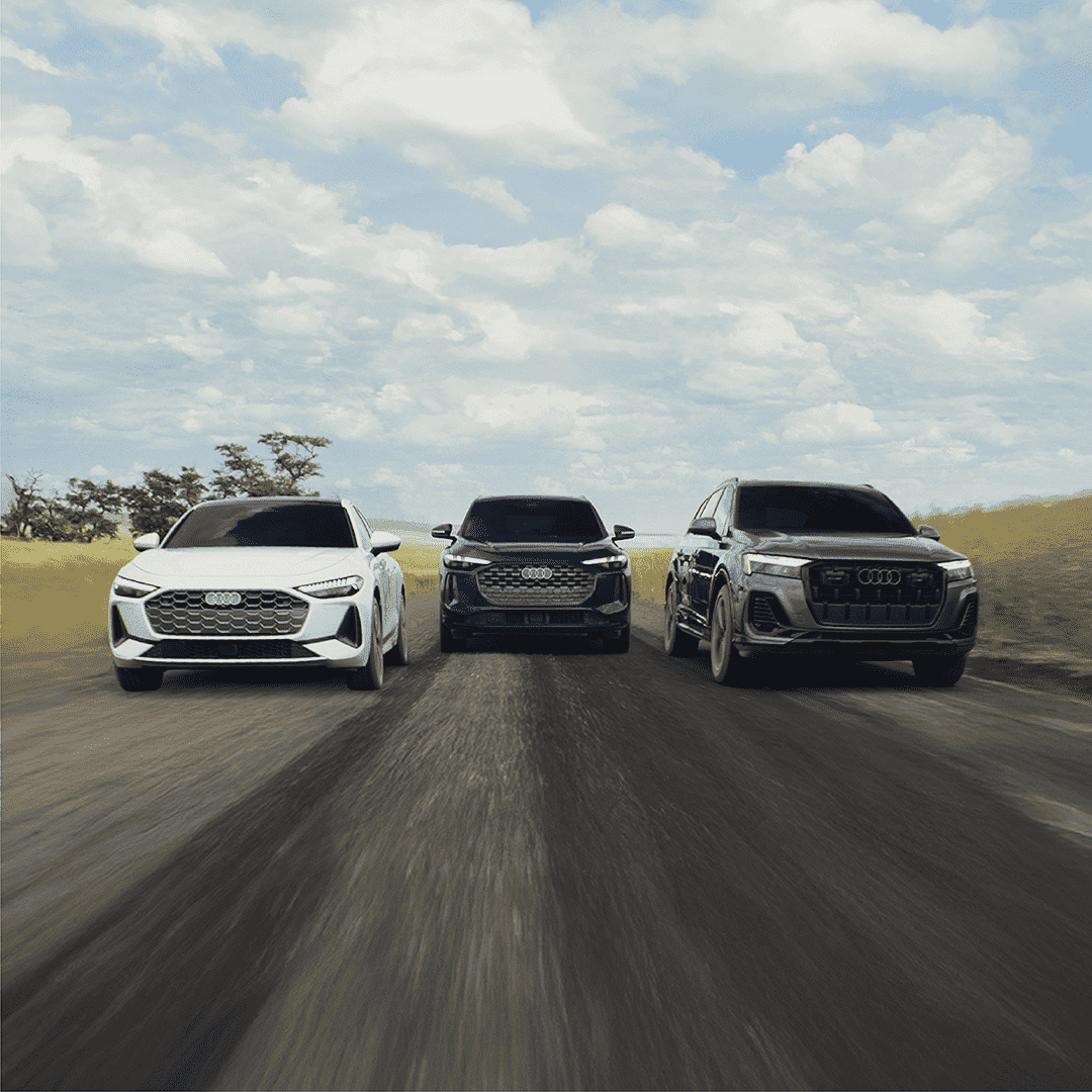 Front facing profile view of Audi's in a lineup, accelerating. 