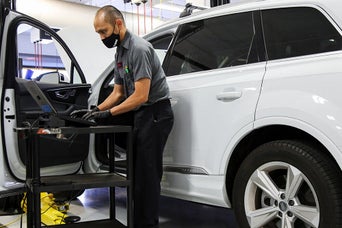 Service technician serving vehicle.