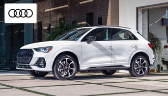2025 Audi Q3 parked in front of the Audi Dayton showroom, showcasing its sleek compact luxury design 