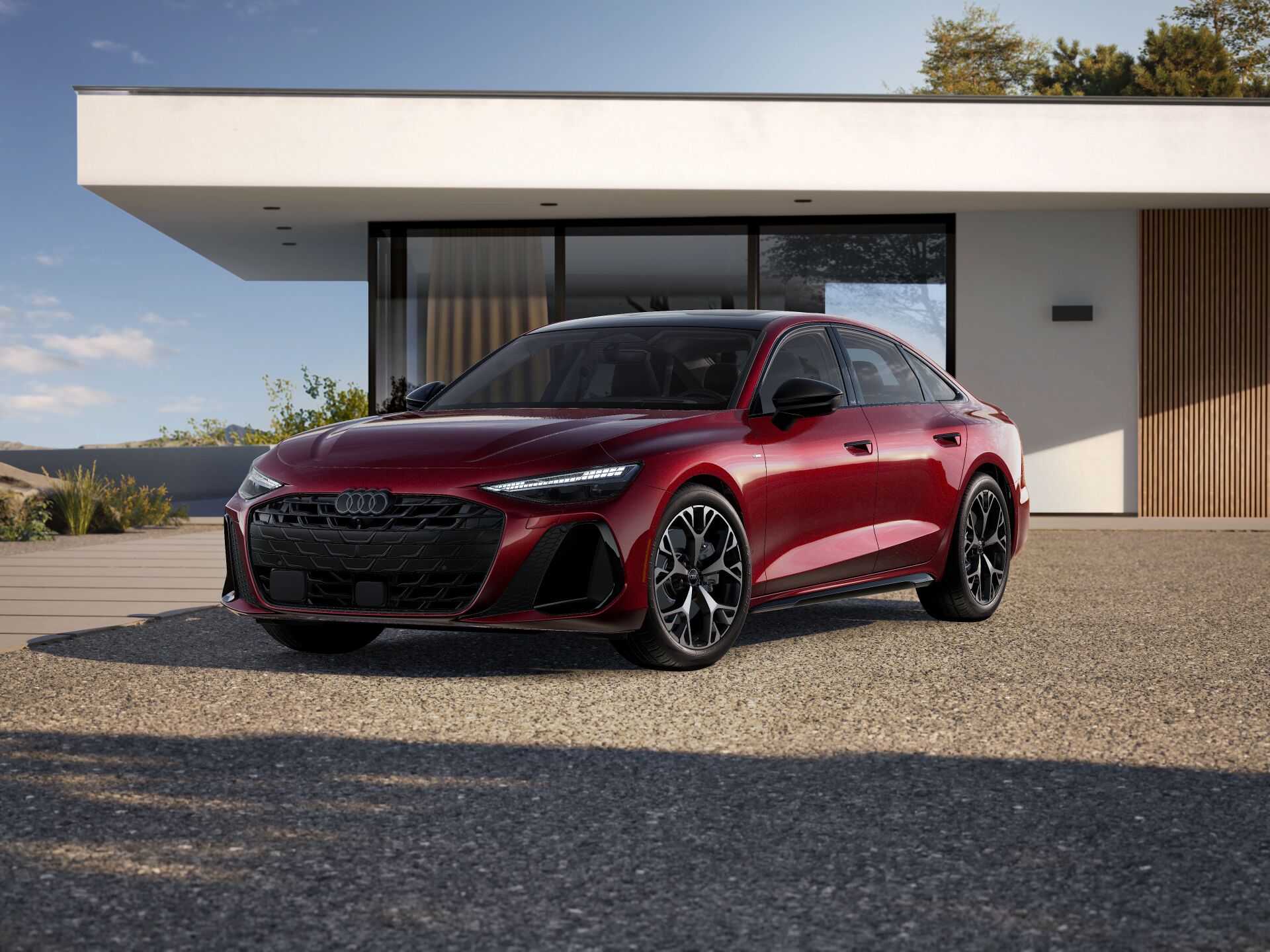2026 Audi A6 Prestige trim in red parked infront of a modern house