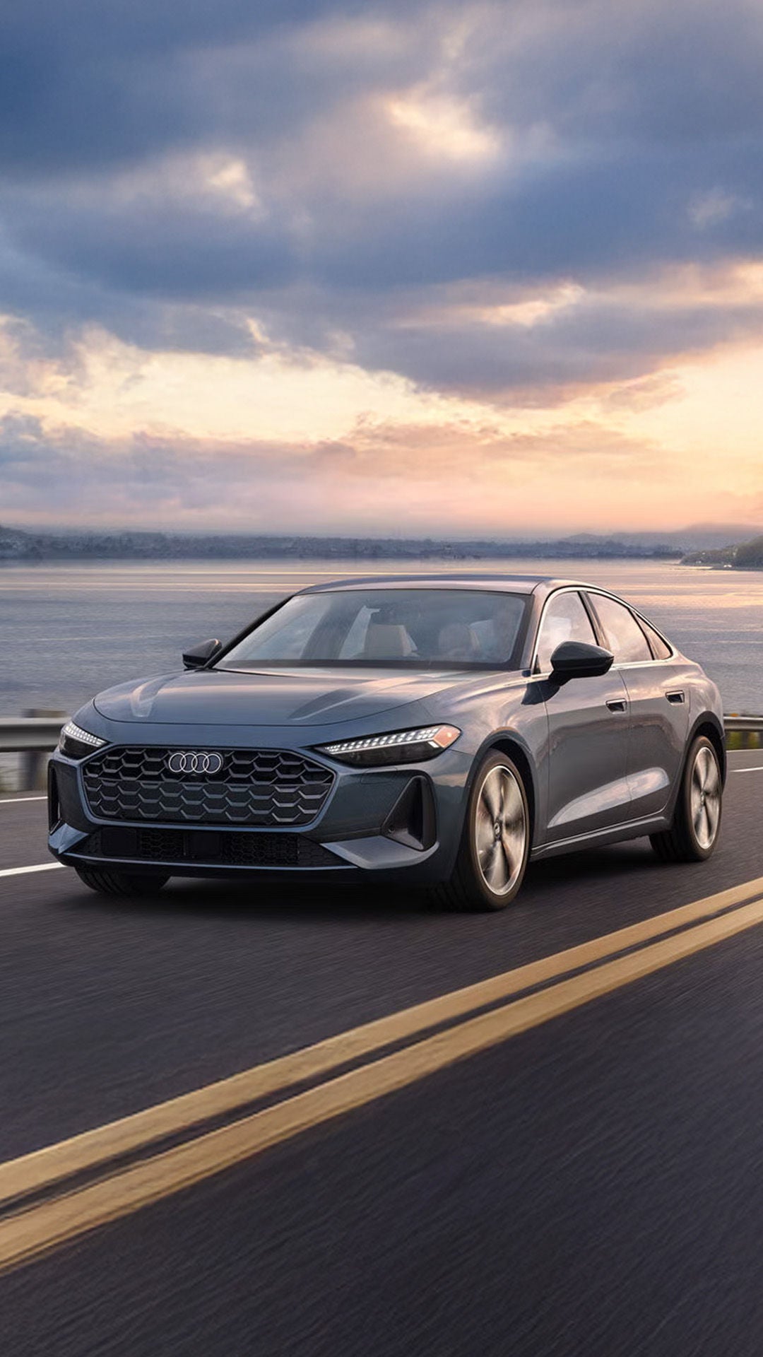 Audi Sedan driving down a road