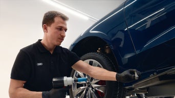 Audi technician working on a vehicle