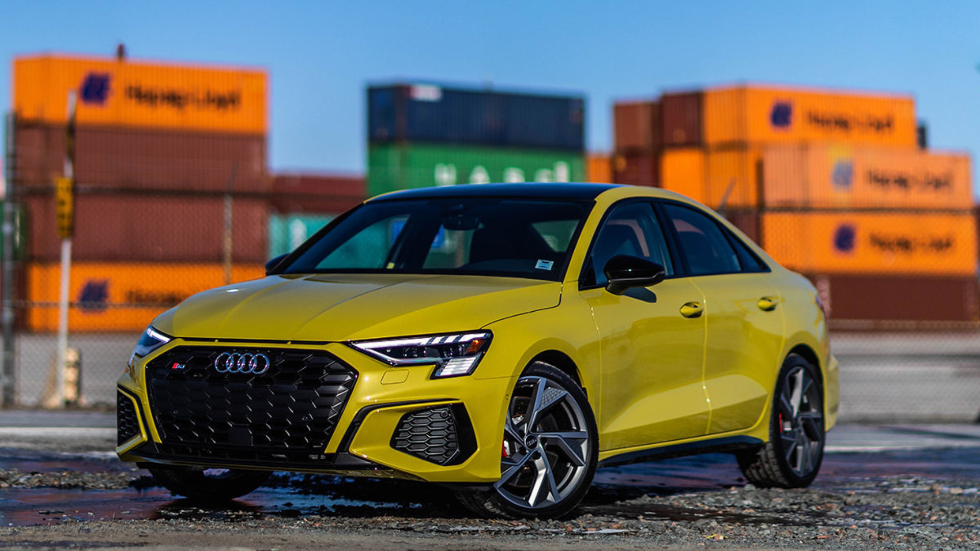 Audi employee handing a set of car keys to a customer.
