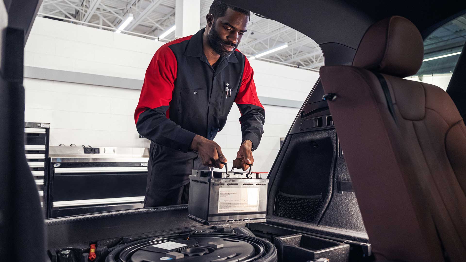 Audi service technician servicing a vehicle.