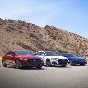 Red, white, and blue Audi parked outside