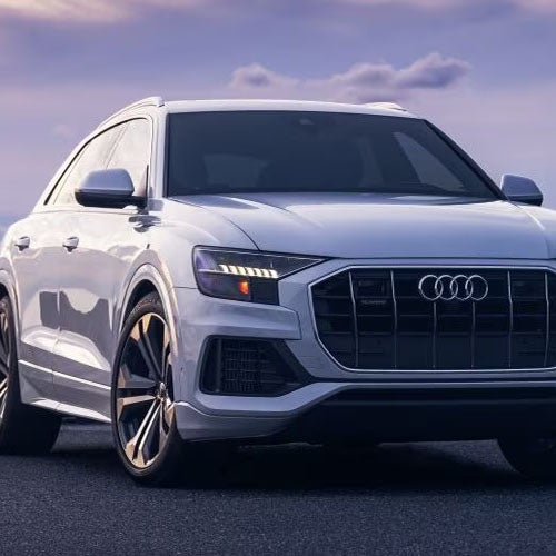 Side profile of an Audi against a natural background.