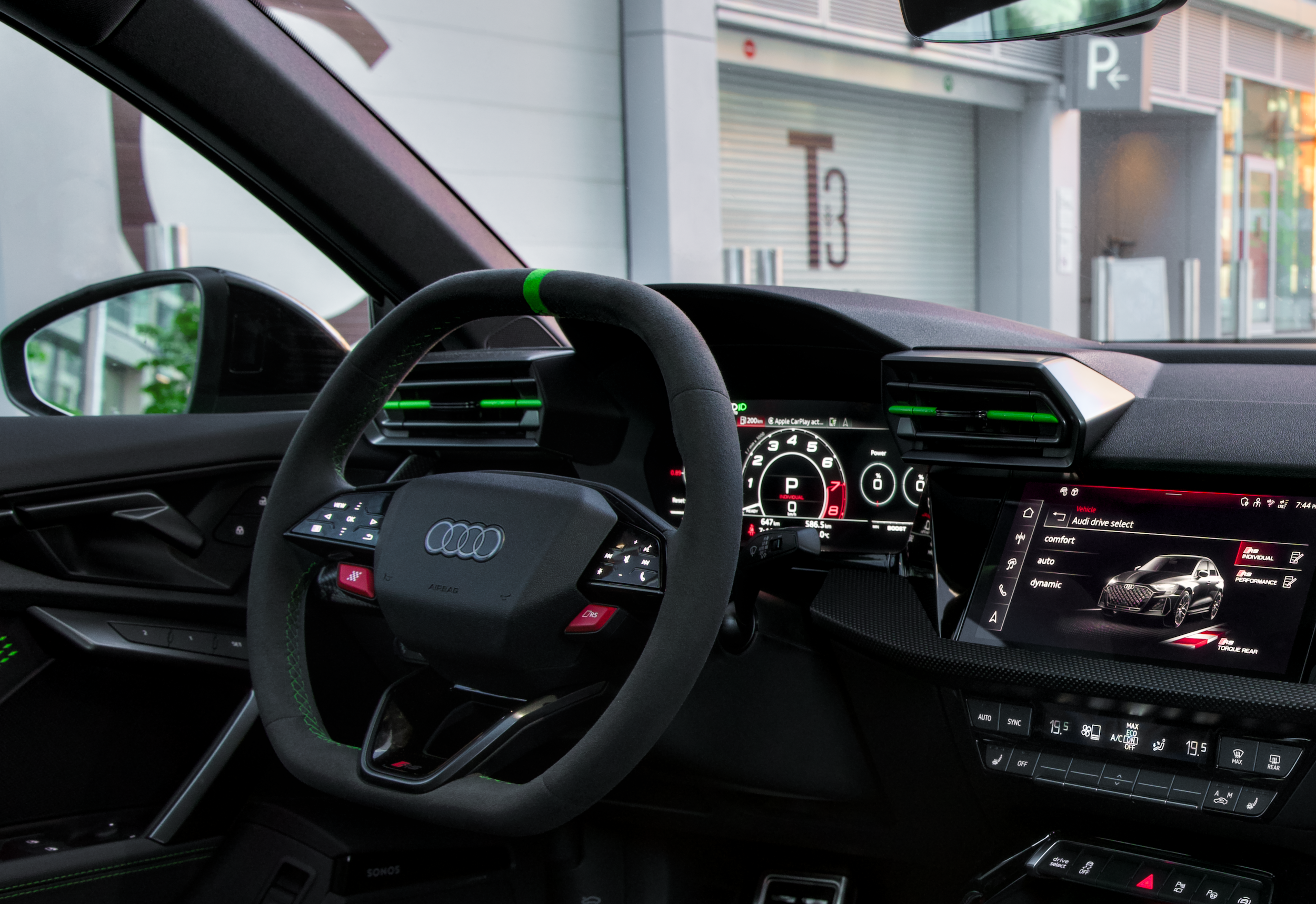 Interior view of an Audi steering wheel and dashboard.