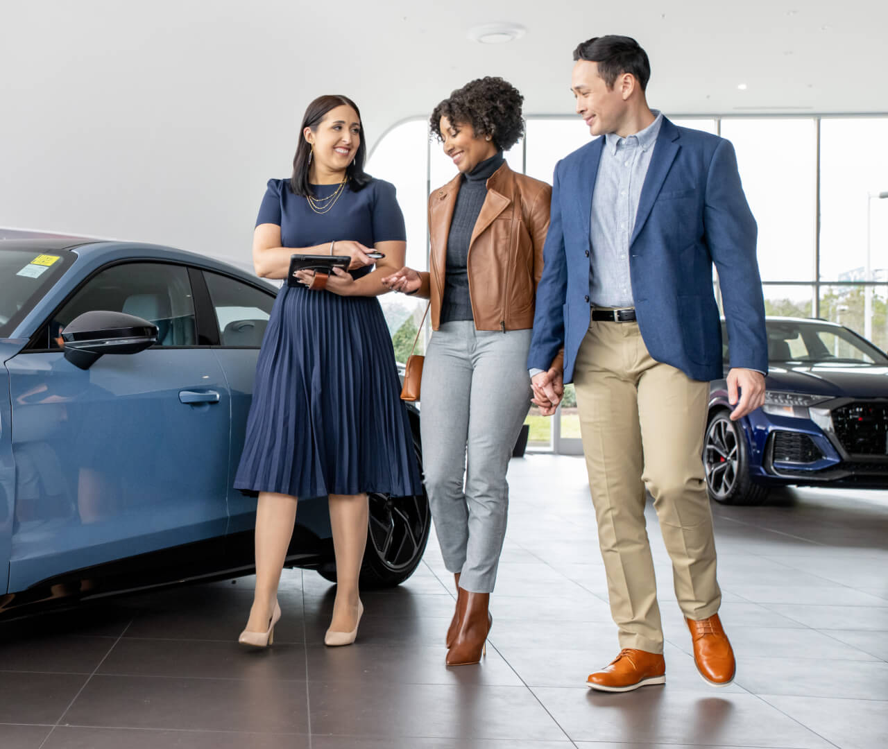 Customers walking and speaking with Audi Sales Representative