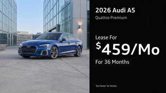 Three quarter view of an Audi A5 driving.