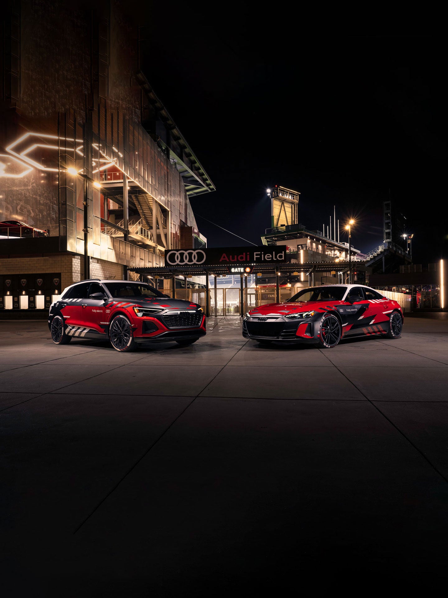 Fireworks going off inside Audi Field while soccer players and fans look on.