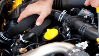 Service technician servicing vehicle.