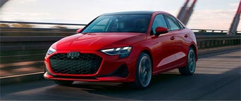 Three quarter view of an Audi A3 driving.