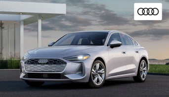 Audi A5 Sportback driving through suburban Dayton, OH, showcasing its sleek profile 