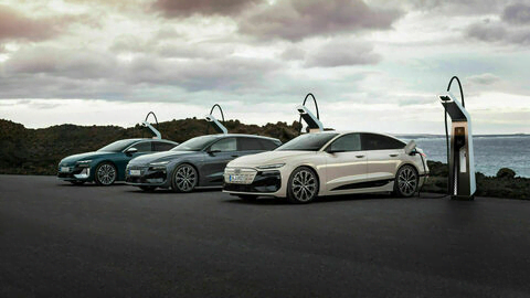 The Audi e-tron lineup parked at a charging station