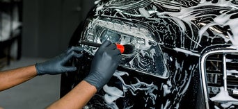 Service technician serving vehicle.