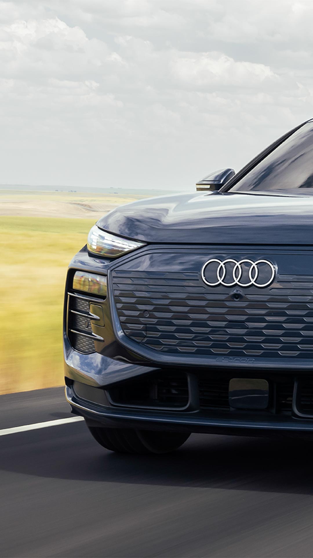 Audi vehicle driving on the road.