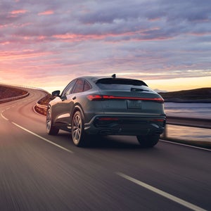 Three-quarter rear view of the Audi Q5 Sportback in motion. 