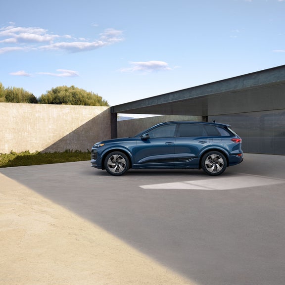 Side view of the Audi Q6 in motion.