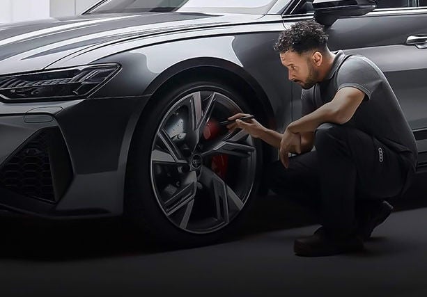 Service technician servicing vehicle. 