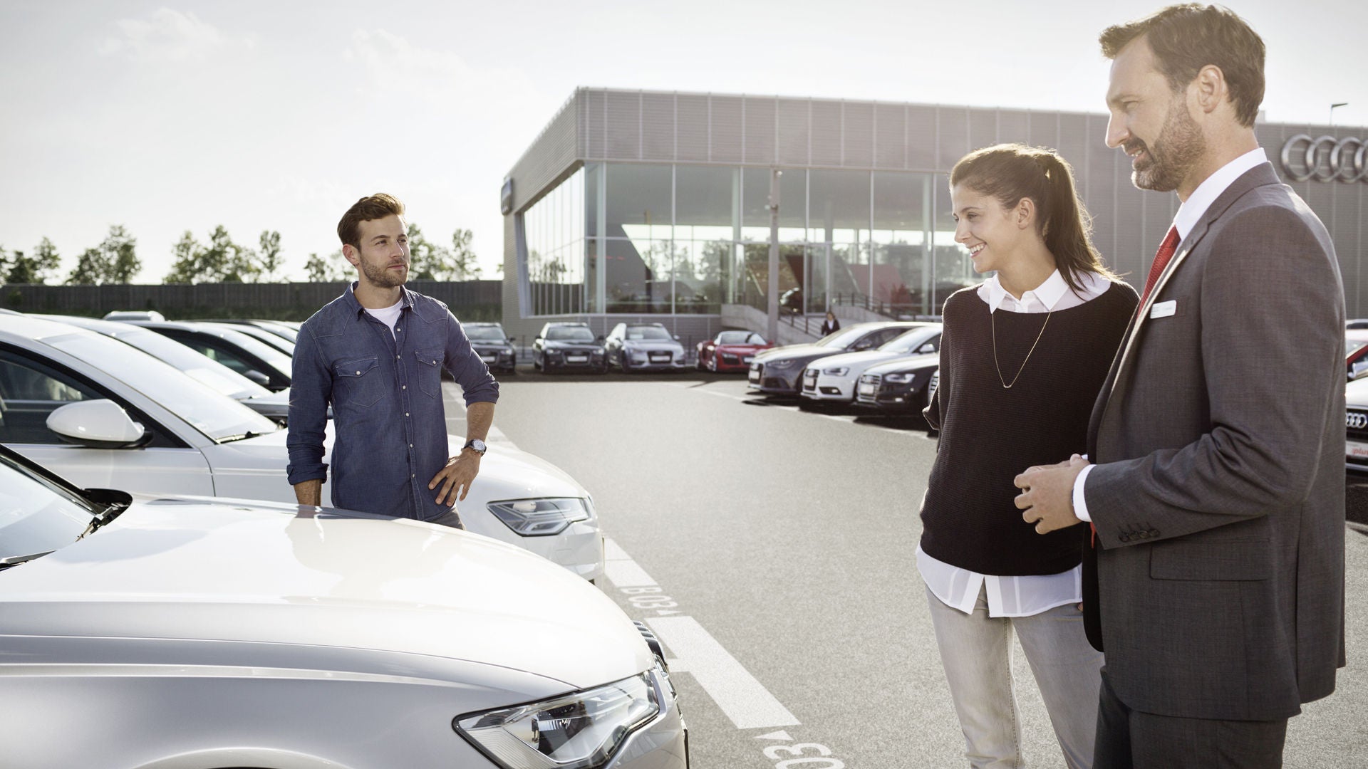An Audi representative assisting a customer to trade in their Audi.