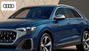  Audi SQ8 parked near a modern Dayton skyline, showcasing its bold styling and performance-focused design. 