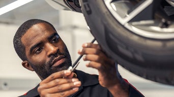 Service technician working on tire.