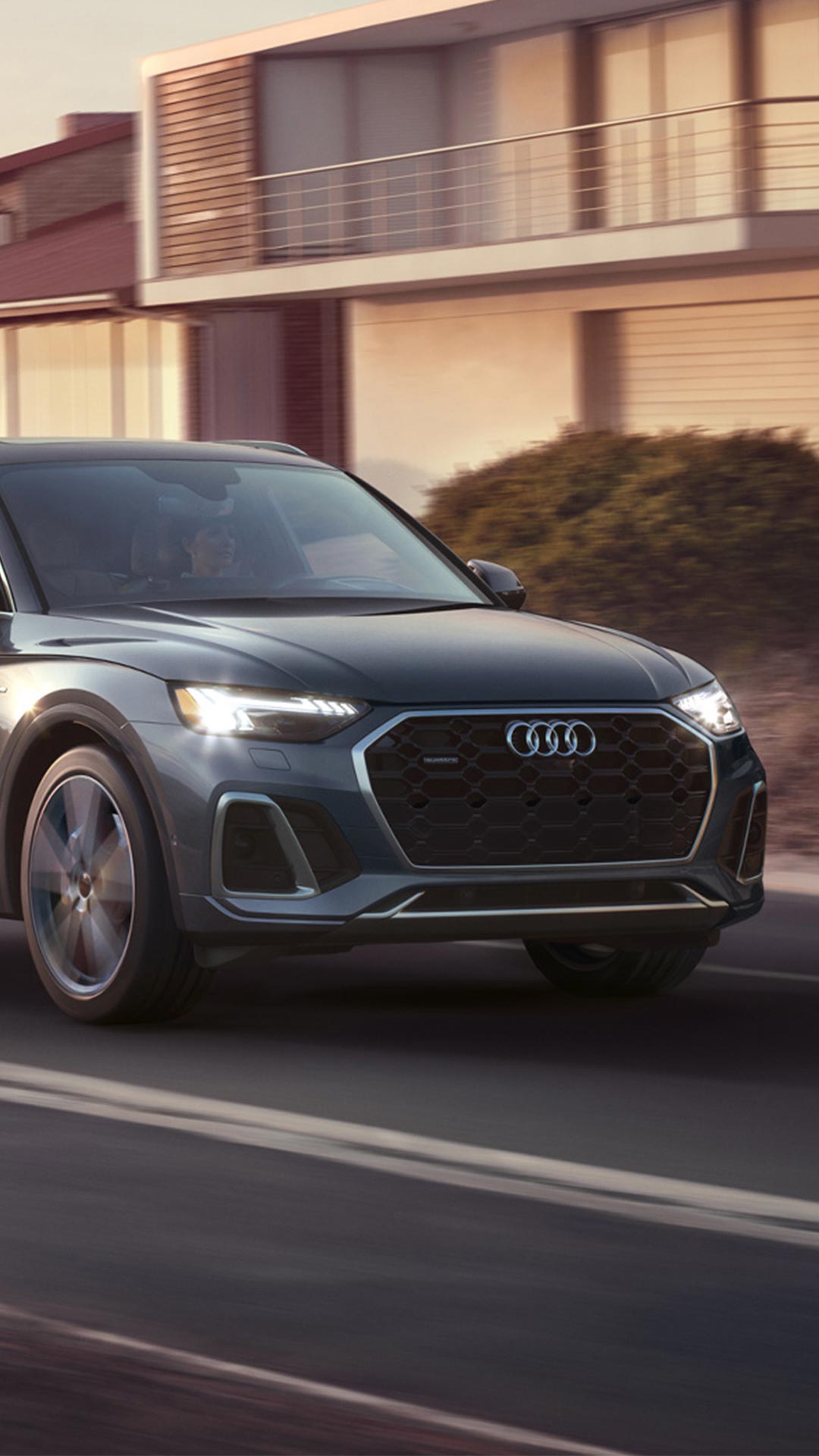 Three quarter view of an Audi Q5 accelerating.