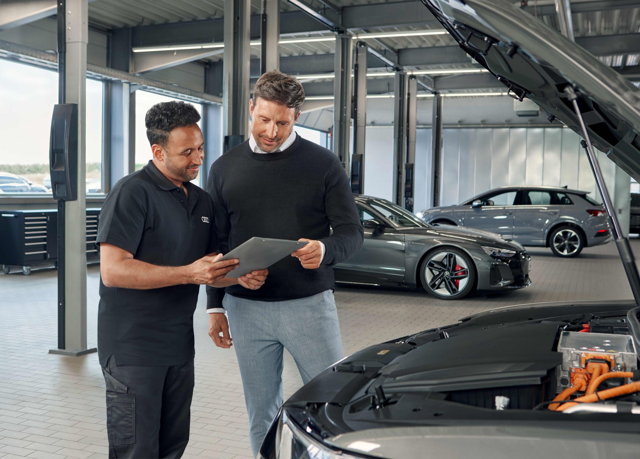 Audi service technician servicing a vehicle.