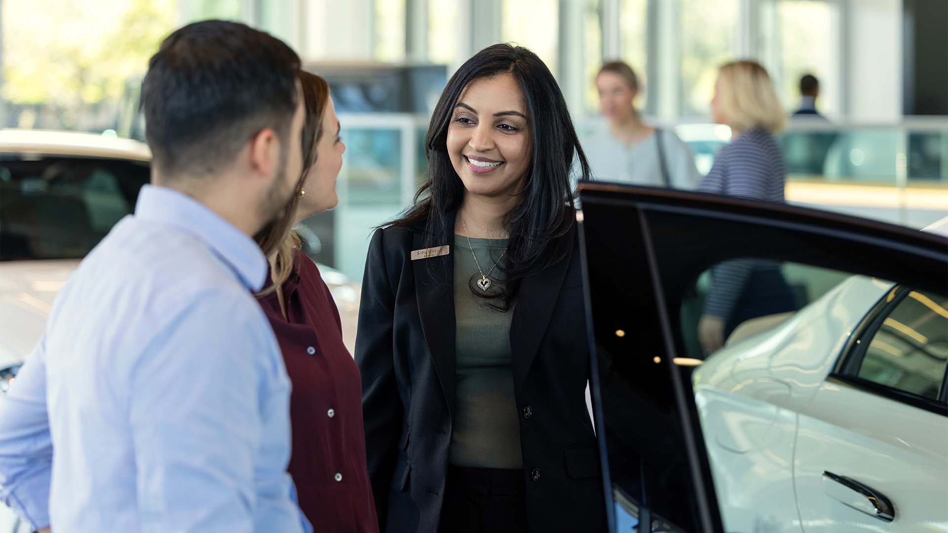Sewell Sales Associate with customers on the showroom
