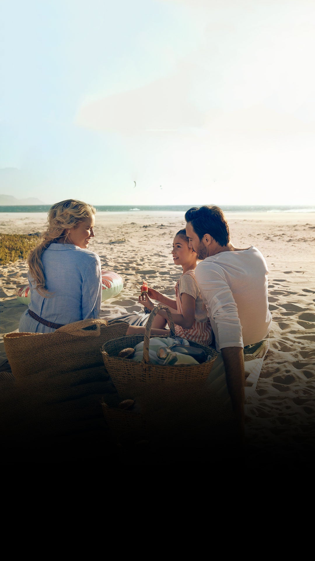 View of a family having a picnic on the beach.