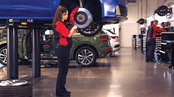 Service technician serving vehicle.