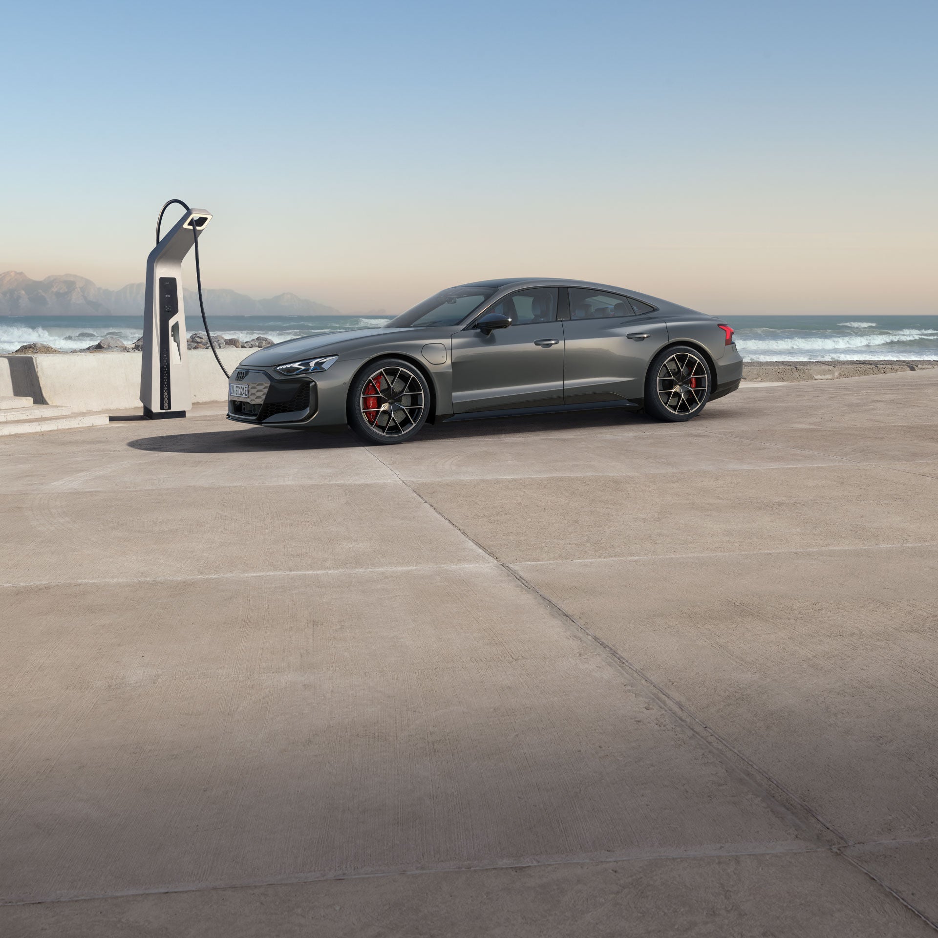 Side profile of the Audi RS e-tron GT parked and charging.