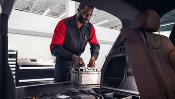Service technician replacing battery.