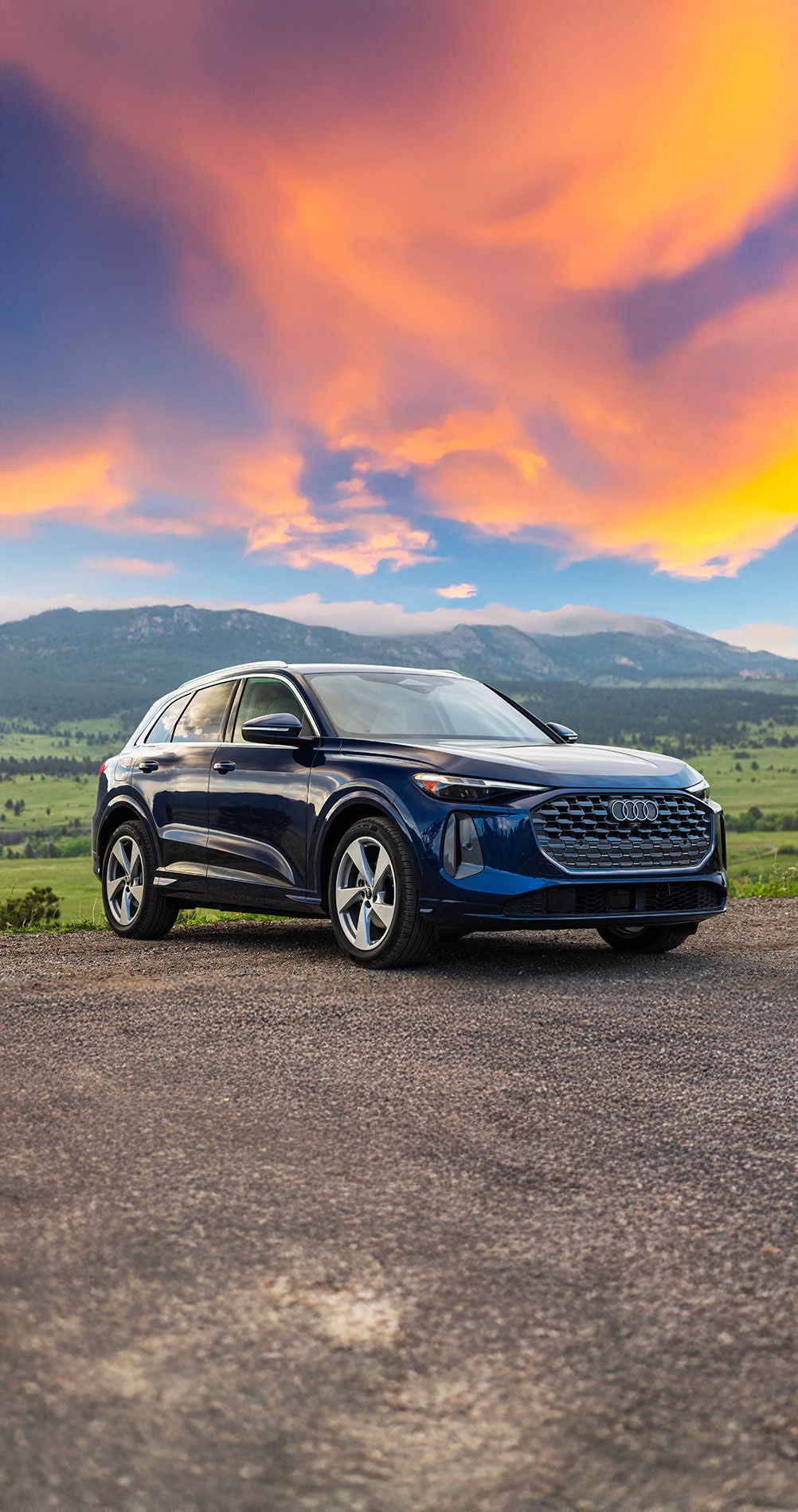 All new 2025 Audi Q5 specs in blue parked by mountains at sunset
