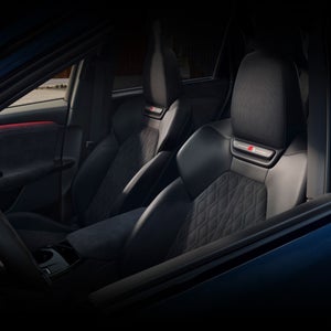 Interior view of the driver's cockpit in the Audi SQ6 e-tron, showing the front sport seats.