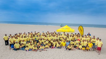 LAcarGuy Team wearing yellow t-shirts at the beach 