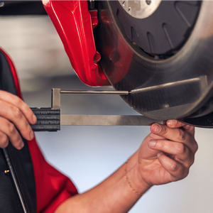 brake measurement with technician's hands