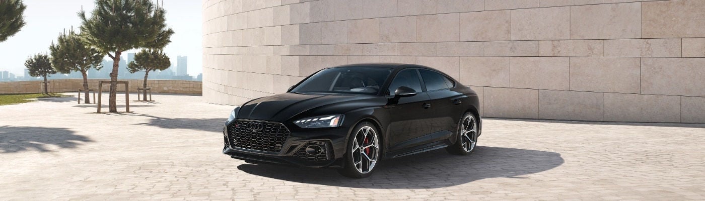 Audi RS5 side view showcasing aggressive stance and sporty lines