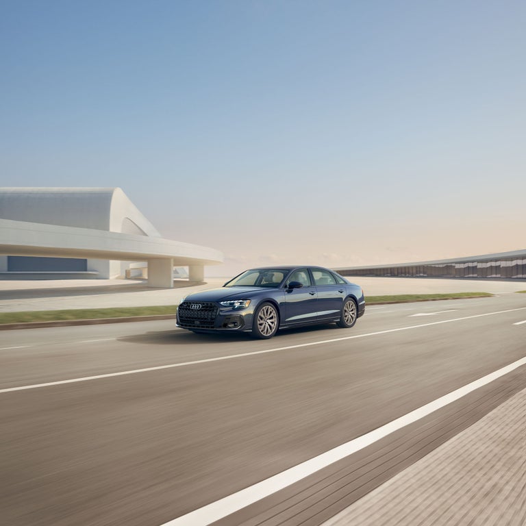 Three-quarter front view of the Audi A8 accelerating.