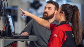 Audi employee assisting customer. 