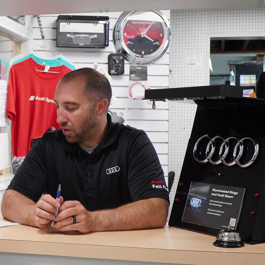 Three-quarter back view of an Audi A4 accelerating. 